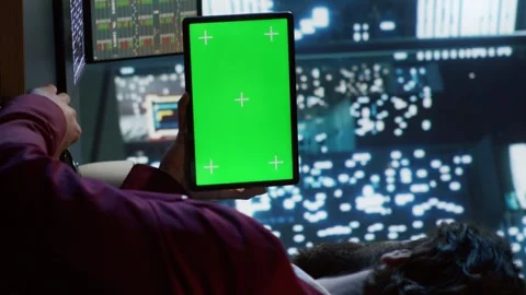 Vertical Video Private equity associate uses greenscreen display on tablet Stock Footage 257970506