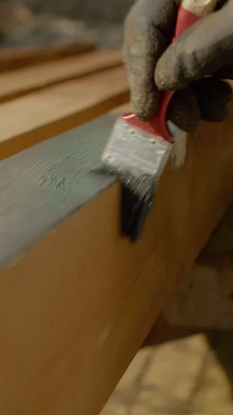 Vertical video Processing wood and applying paint with a brush in outdoor Stock Footage 327600596