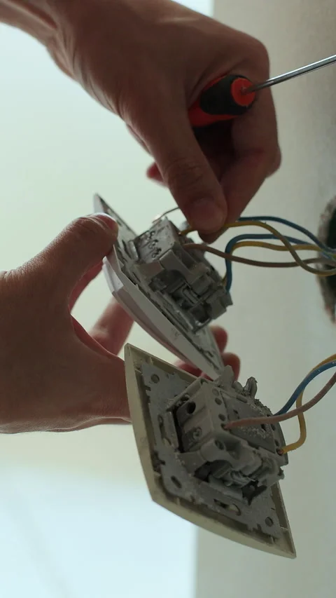 Vertical video Professional electrician working on a home electrical system. Stock Footage 339061927