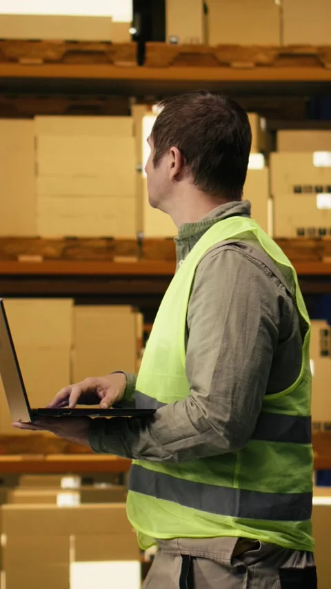 Vertical Video Professional worker reviewing inventory data in warehouse Stock Footage 333090766