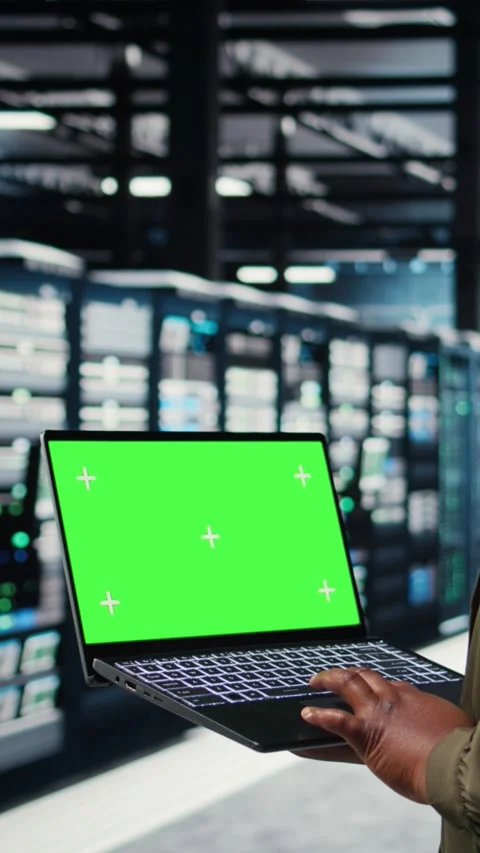 Vertical video Programmer in data center using app on isolated screen laptop t Stock Footage 317053955