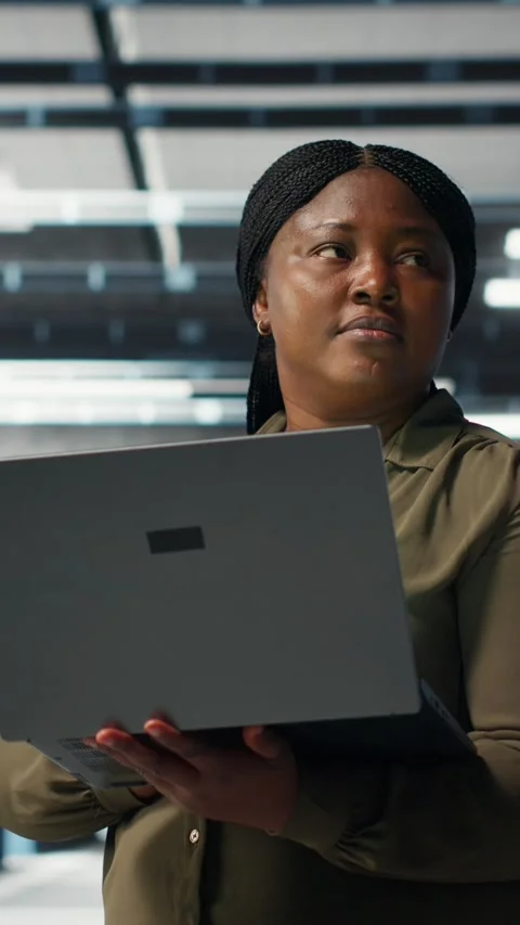 Vertical video Programmer in data center using laptop to deploy new server Stock-Footage 317054361