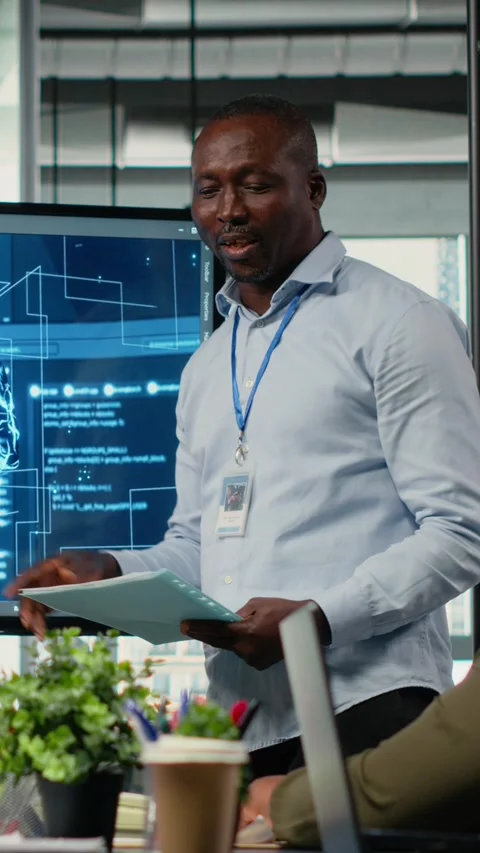Vertical video Programmer gives presentation to executives, implementing AI Stock Footage 323142506