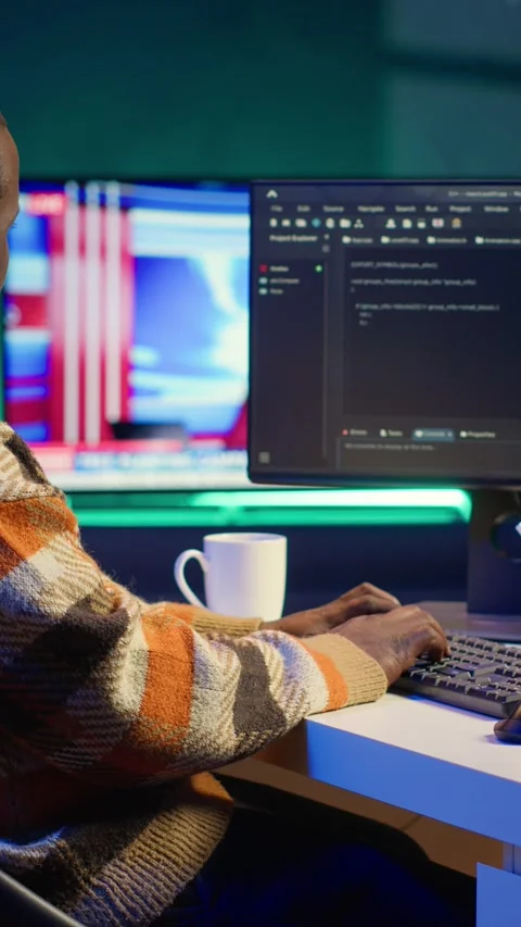 Vertical Video Programmer in home office concentrating on finding bugs while he Stock Footage 319549207
