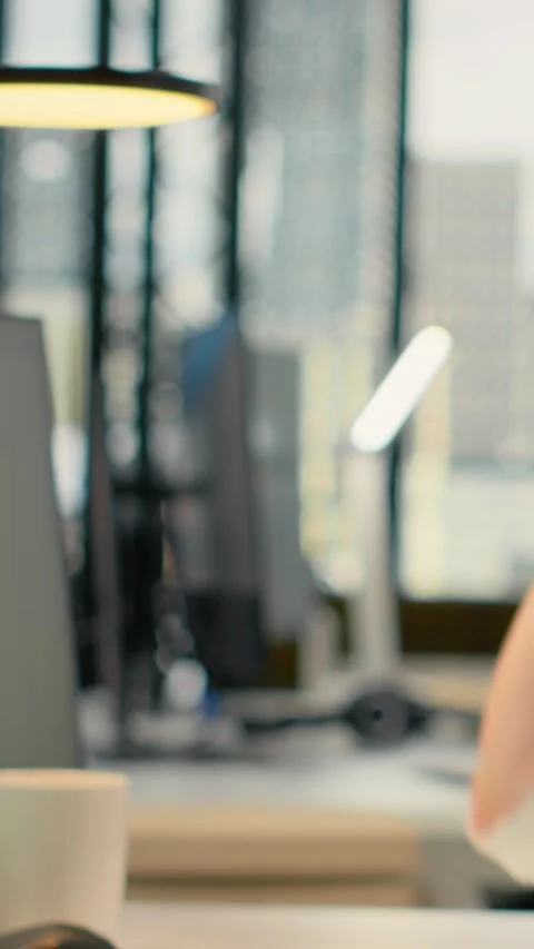 Vertical video Programmer in office listening music, automating workflows using Stock Footage 323143128