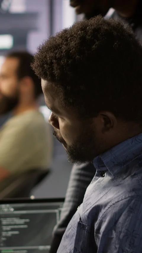 Vertical video Programmer waiting for coworker to come help him fix applications Stock-Footage 319476096