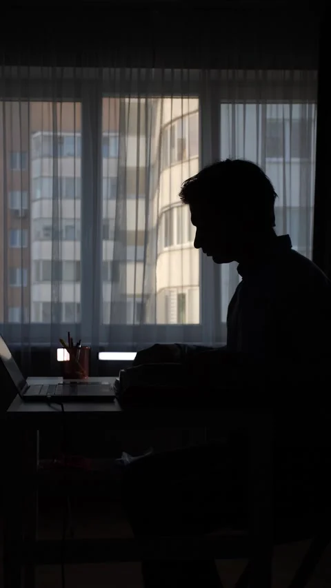 Vertical video Programmer working from home in dark room with laptop Stock Footage 308406902