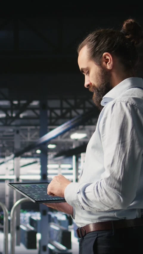 Vertical video Programmers on data center industrial platform checking code on Video stock 310774970