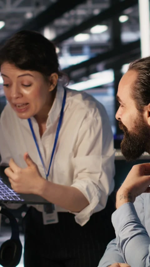 Vertical video Programmers doing brainstorming in server room, reviewing AI code Stock Footage 309486806