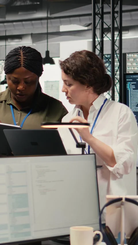 Vertical video Programmers in office automating workflows using artificial Stock Footage 322696195