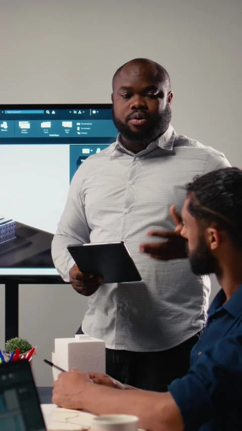 Vertical Video Property developer leads the planning session with 3D models for Stock Footage 316340405