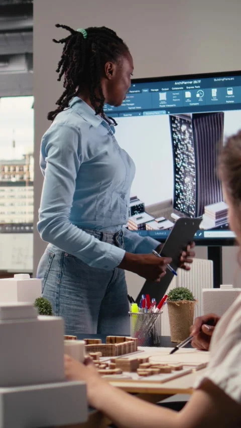 Vertical Video Property development team evaluating 3D models structural layout Stock Footage 316183392