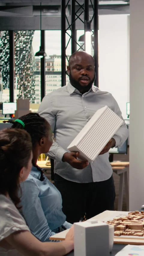 Vertical Video Property engineers team study architectural blueprints with a Stock Footage 316340326