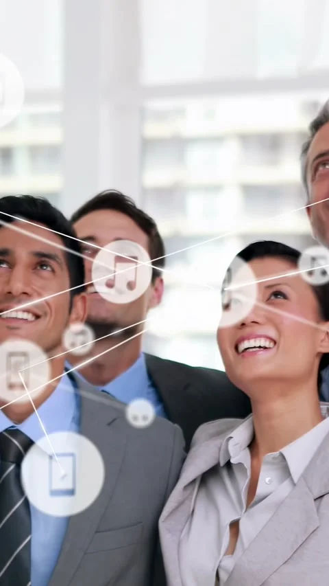 Vertical video: Pullback revealing team gazing up while phone icons overlaying Video stock 334602524
