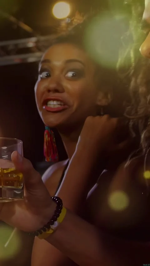 Vertical video: Pullback revealing woman turning and offering toast at bar while Stock Footage 334390399