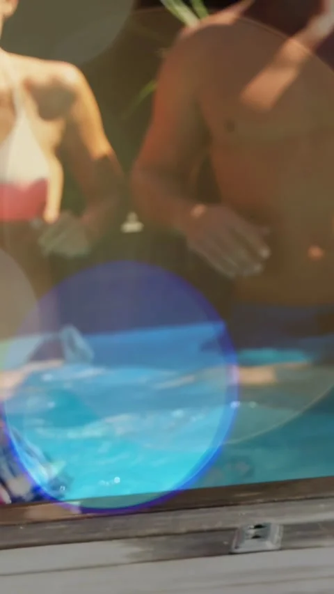 Vertical video: Pullback showing man and bikini woman at pool smiling with cup, Stock-Footage 333896154
