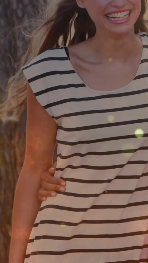 Vertical video: Pullback showing woman smiling as hand touching waist, warm Stock Footage 331463922