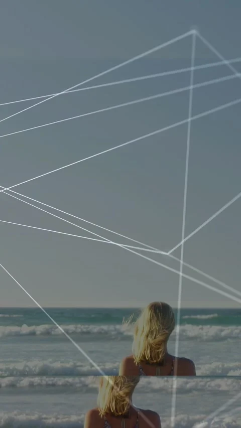 Vertical video: Pullback showing woman walking into sea, watching sea, tech Stock-Footage 333744565
