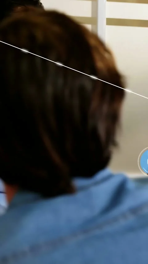 Vertical video: Pullback showing woman turning in tech meet, blue UI icons Stock Footage 335513749