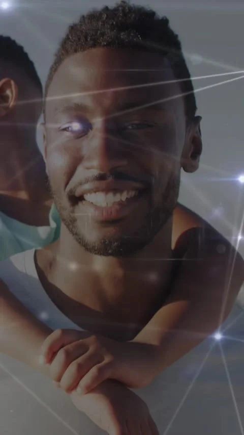 Vertical video: Pullback sparking tech overlay over faces while dad carrying Video stock 334187451