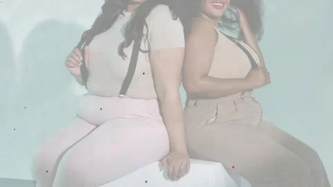 Vertical video: Pulling camera back filming two models adjusting braces tossing Stock Footage 334176703