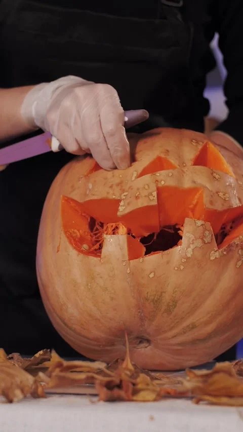 Vertical Video: Pumpkin Carving Jack-O-Lantern Close-Up. Stock Footage 320886319