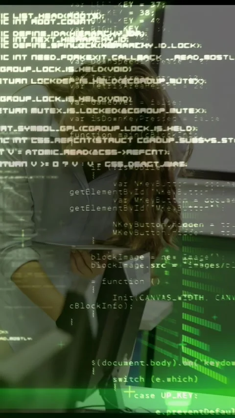 Vertical video: Pupil typing, teacher leaning in, guiding code, green tech Stock Footage 330655455