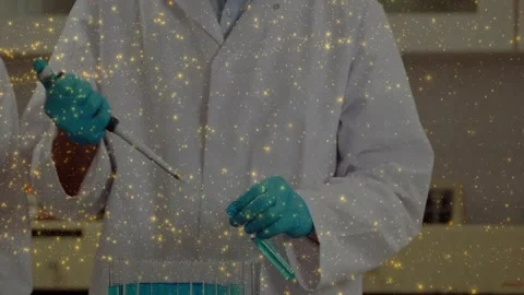 Vertical video: Pushing plunger causing tech in coat pipetting blue samples at Stock Footage 331503267