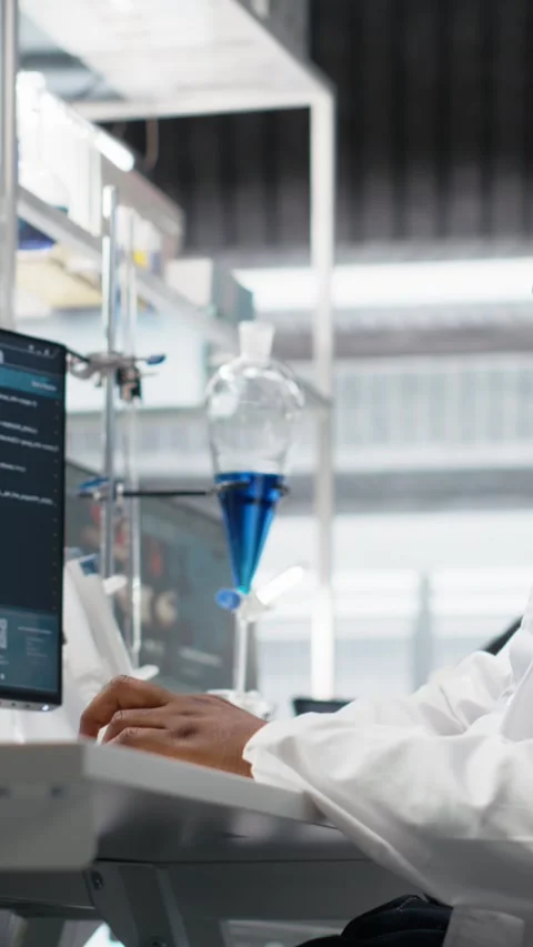 Vertical video Quality control analyst in laboratory analyzing solution at Stock Footage 319506225
