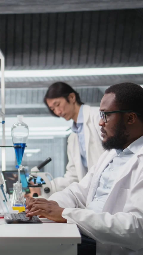 Vertical video Quality control analyst in laboratory analyzing solution at Stock Footage 319506643