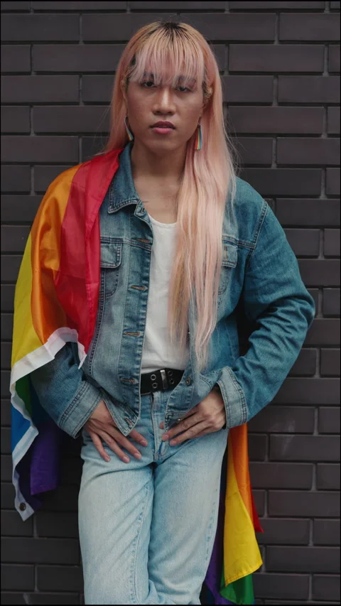 Vertical Video. Queer Guy in a Wig Standing Stylishly Dressed, Posing in Front Stock Footage 311581939