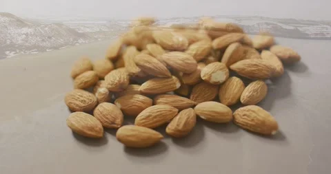 Vertical video: Racking focus, camera sharpening almond pile on tabletop, Stock Footage 331404460