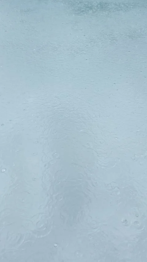Vertical Video, Rain Splashing on Blue Pool Water, Thunderstorm Miami, 4K Stock Footage 341367483