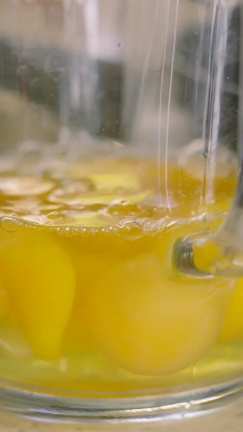 Vertical Video of Raw Eggs in Measuring Jug with One Egg Being Poured in Slow Stock Footage 307835107