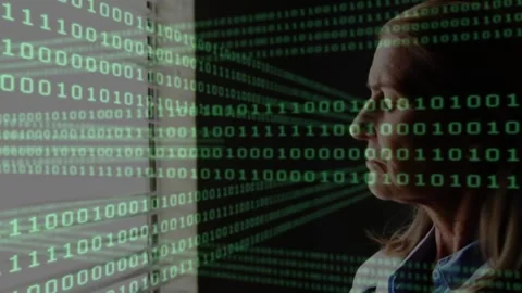 Vertical video: Reacting to binary code, senior in blue shirt checking device at Stock Footage 334112298