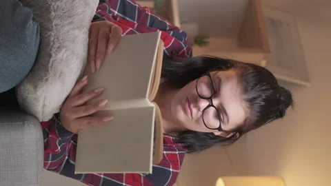 Vertical video reading leisure smart woman book Stock Footage 231053317