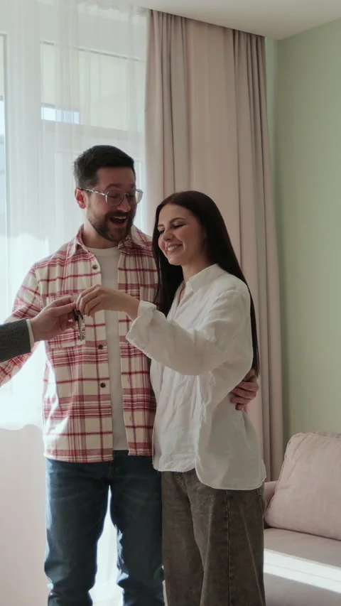 Vertical video Real estate agent is giving keys to buyers of new apartment. Stock Footage 340083213