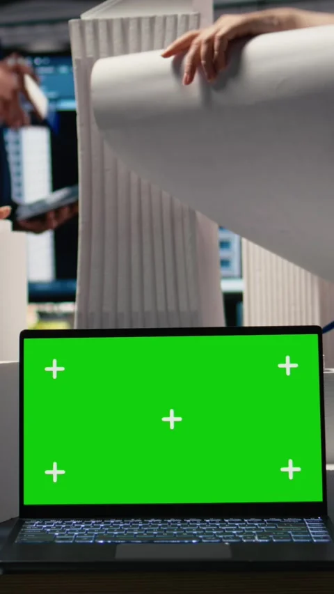 Vertical Video Real estate experts analyzing blueprints and models next to green Stock Footage 316340256