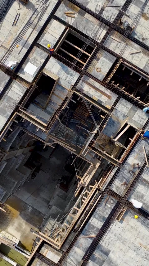 Vertical Video: Real estate project under construction where workers are setting Stock-Footage 297638668