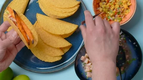 Vertical video recipes: the cook makes homemade tacos with salmon and spicy Stock Footage 180946998