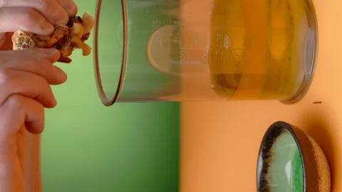 Vertical video recipes: the cook squeezes baked garlic to the blender bowl and Video stock 183534396