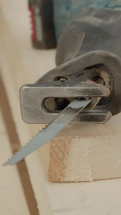 Vertical video Reciprocating saw in action at a bustling construction site Stock Footage 327601188
