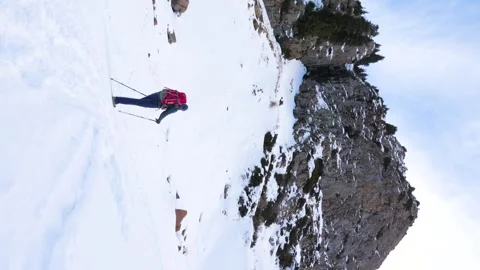 Vertical video recording of a man making a winter hike in the mountains Stock Footage 262522071