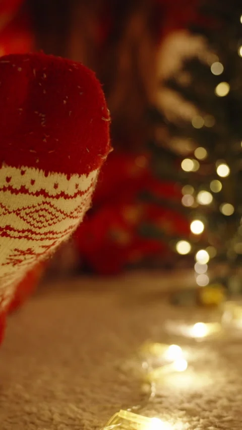 Vertical video. Red and White Christmas Sock in Foreground with Decorated Mini Stock Footage 316769239
