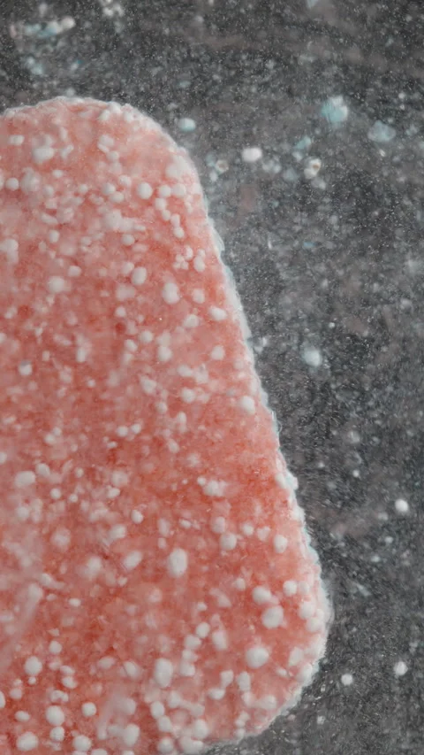 Vertical video. Red Dishwasher Tablet Agitated with a Stick, Rapid Dissolution Vidéo 283308152