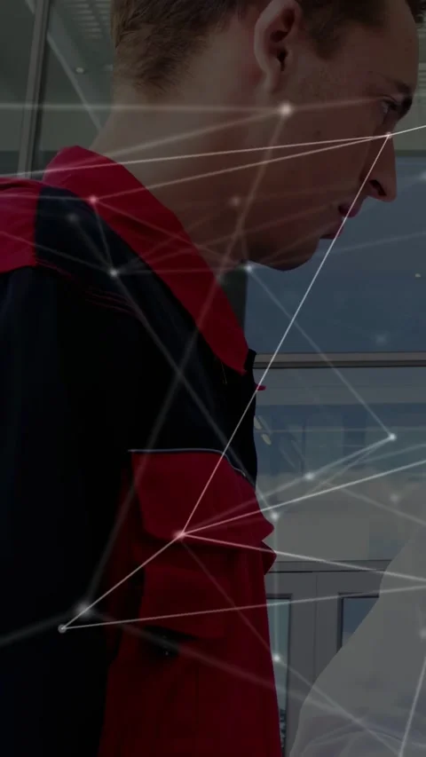 Vertical video: Red-jacket worker leaning in building after gloved hand gesture, Stock Footage 333036873