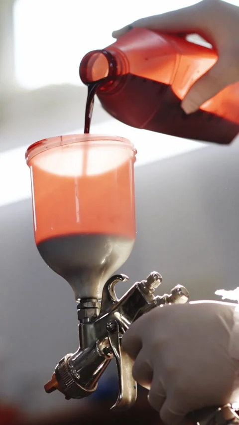 Vertical video of Red paint for car painting. Spray gun for car painting Stock Footage 303842972