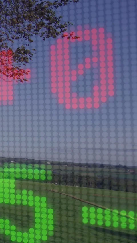 Vertical video: Red plus appearing, clear LED grid cycling red green digits over Stock-Footage 334598616