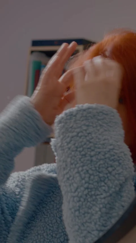 Vertical video Redhead woman checking her look in the mirror Stock Footage 306128200