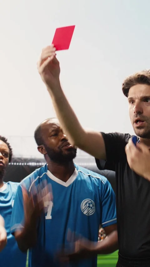 Vertical Video Referee raising red card toward soccer player protesting Stock Footage 338046886